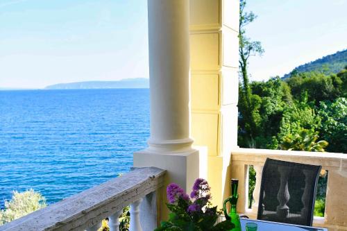 a view of the ocean from a house balcony at Apartment Carissima-Direct on sea, Lovran-Opatija in Lovran