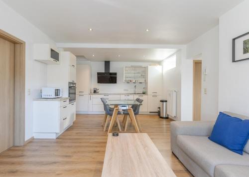 a living room with a couch and a table at Appartement avec RoofTop au centre de Malmedy in Malmedy