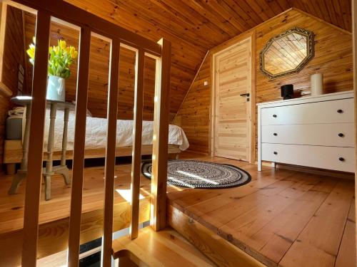 a bedroom with a bed in a wooden cabin at Domek letniskowy Sosenka in Woryty