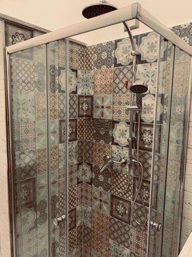 a shower in a bathroom with tiles on the wall at Casa Vacanza Elena in Capo dʼOrlando