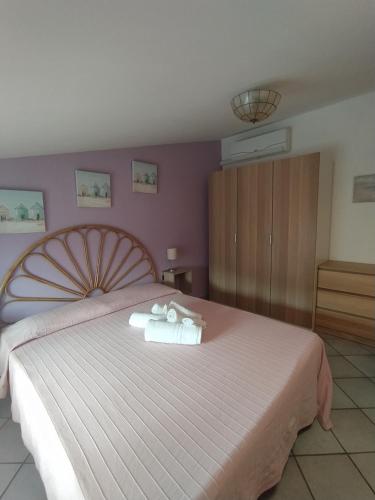 a bedroom with a large bed with towels on it at Bilocale La Tezia in Marciana Marina
