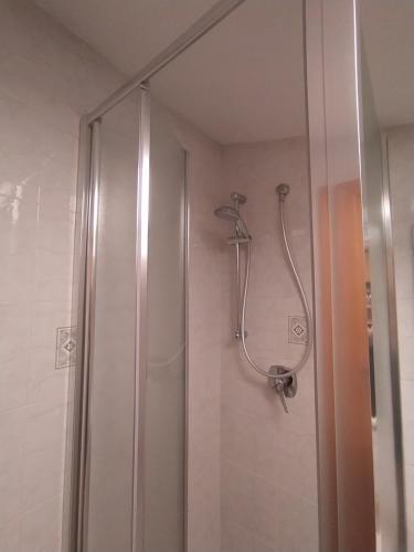 a shower with a glass door in a bathroom at Bilocale La Tezia in Marciana Marina
