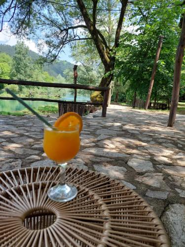 a glass of orange juice sitting on a table at ATRIUM Holiday home in Bihać
