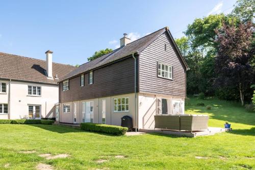 a house with a large yard in front of it at Osbornes Holiday House near Exeter with swimming pool in Exeter