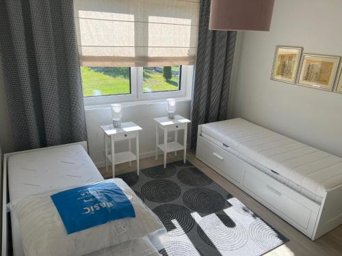 a small bedroom with a bed and two night stands at Apartament U Kucharzy Łysica 2 in Wilków