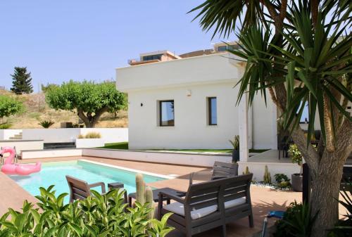 a villa with a swimming pool and a house at Valenti rooms & relax in Villaggio Mosè