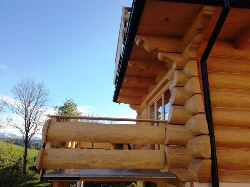 a view of the outside of a log cabin with a deck at Domki Góralskie Dwa Misie in Bukowina Tatrzańska