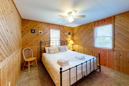 a bedroom with a bed and a ceiling fan at The Sea Salt Cottage at Geri's Place 304 in Nags Head