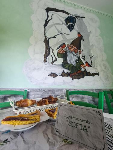 a table with bread and a painting on the wall at Agriturismo le Fontane - Lago di Bolsena in Grotte di Castro
