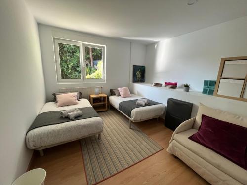 a living room with two beds and a couch at Kizkitza in Gautegiz Arteaga