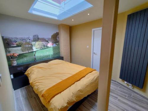 a bedroom with a bed and a skylight at Mote26 in Ingooigem