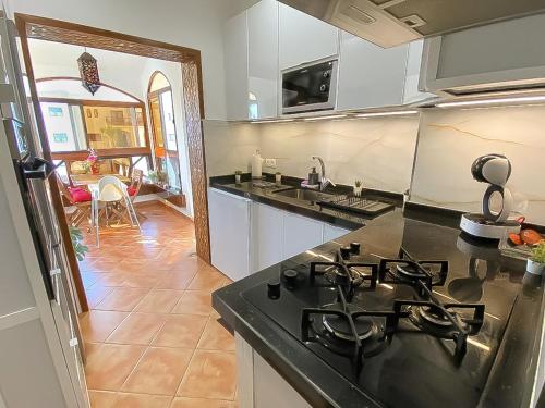 a kitchen with a stove and a counter top at LuxuryStay by Al Amir in Martil