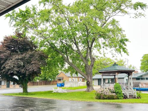 a house with a gazebo and a tree at Viking Arms Inn - Ludington in Ludington