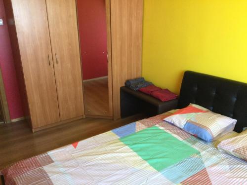a bedroom with a bed with a colorful quilt at 2 Kambariu butas.Apartments-in the city UKMERGE. in Ukmergė