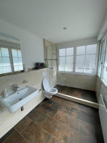 y baño con lavabo, aseo y bañera. en Moderne einzigartige Wohnung in Altdorf, en Altdorf