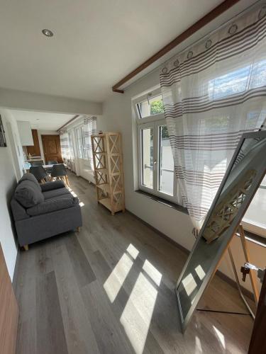 a living room with a couch and a window at Moderne einzigartige Wohnung in Altdorf in Altdorf