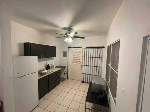 a kitchen with a ceiling fan and a white refrigerator at Large 5 Bedrooms Home in Bayamon Puerto Rico in Bayamon