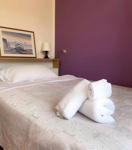 a hotel room with a bed with towels on it at Amica in Salsomaggiore Terme