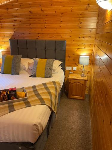 a bedroom with a bed in a wooden cabin at L10 - The Conwy Spa with Hot Tub in Bethesda
