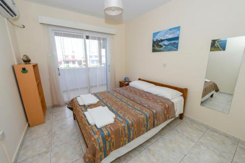 a small bedroom with a bed and a mirror at The Valley Beyond in Paralimni