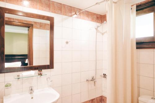 a bathroom with a sink and a mirror at Althaia Hotel in Thermo