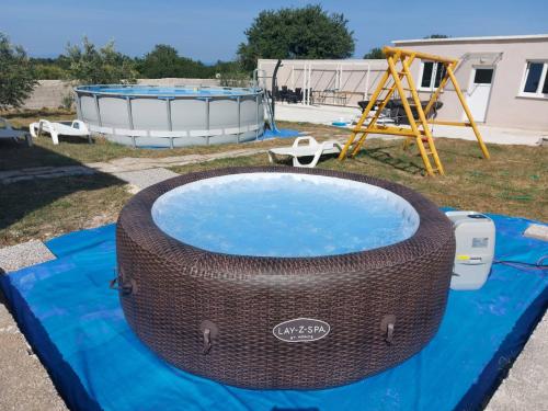 a large tire on a blue tarp next to a playground at Apartment Stanko in Ližnjan