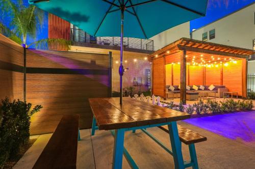 a patio with a table and an umbrella at Private Townhouse in a Secure Location in New Orleans