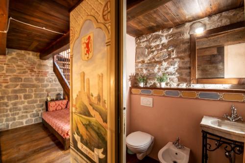 a bathroom with a sink and a toilet in a room at Medieval Tower Lungarno your wedding in Tuscany in Pratovecchio