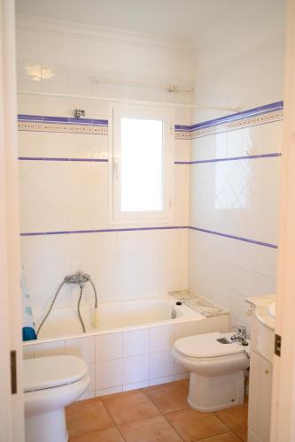 a bathroom with a tub and a toilet and a sink at Quite villa with private pool in Binibeca in Binibeca