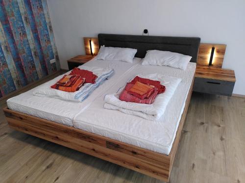 a bed with a white comforter and pillows on it at Hostel Bad Salzig in Boppard