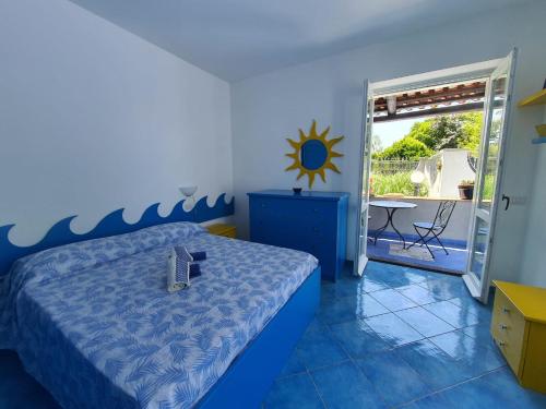 a bedroom with a bed with a laptop on it at Casa Rossella in Procida