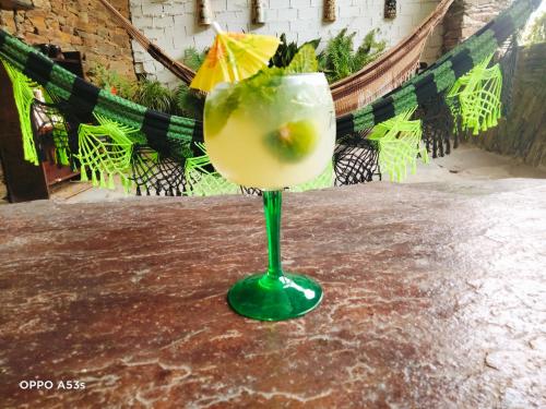 a green glass with a lime in it on a table at Pensión Santa Rosa in Samos