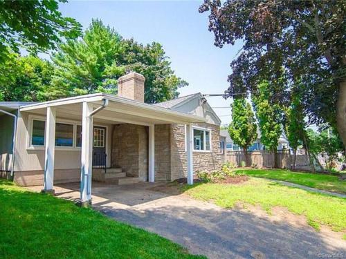 a brick house with a porch and a driveway at Shore Drive - 2 Bedroom/2 Bath/Bunk/Queen Oasis in Waterford