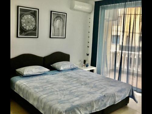 a bedroom with a large bed and a window at DK Apartmani in Dobra Voda