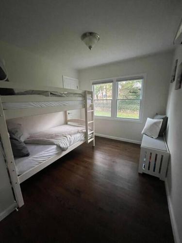 a room with two bunk beds and a window at Shore Drive - 2 Bedroom/2 Bath/Bunk/Queen Oasis in Waterford