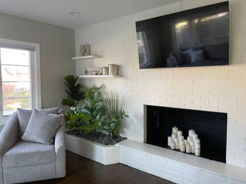 a living room with a fireplace and a chair at Shore Drive - 2 Bedroom/2 Bath/Bunk/Queen Oasis in Waterford