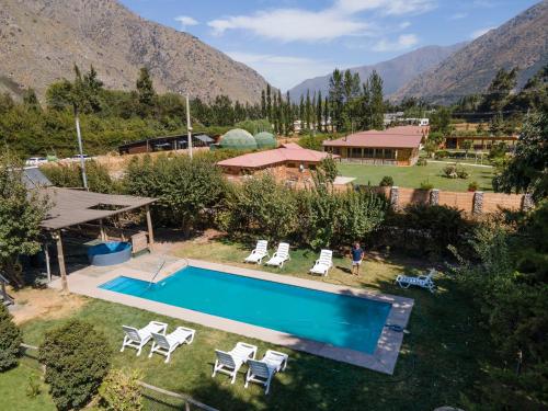 an overhead view of a pool with chairs and a house at La Casa de Carlitos in San José de Maipo