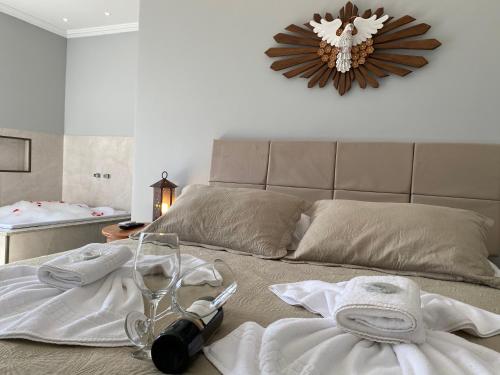 a bedroom with a bed with towels and a mirror at Pousada Maria Monteiro Tiradentes in Tiradentes