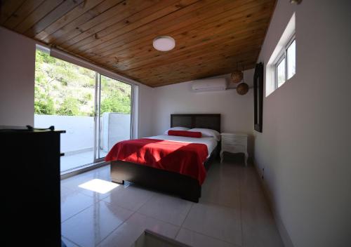 a bedroom with a bed and a large window at Imagine Beach in Puerto Colombia