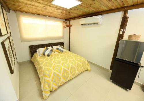 a bedroom with a bed in a small room at Imagine Beach in Puerto Colombia