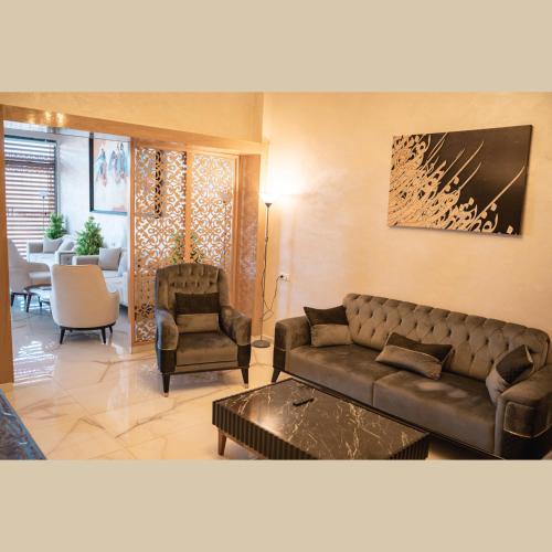 a living room with a couch and a chair at Moussa Residence in Dakhla