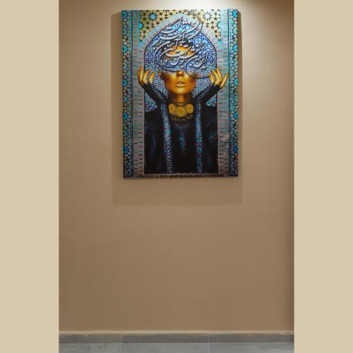 a painting of a woman on a wall in a museum at Moussa Residence in Dakhla