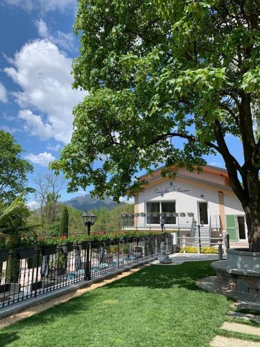 a house with a fence in front of a yard at Casale al Foino in Induno Olona