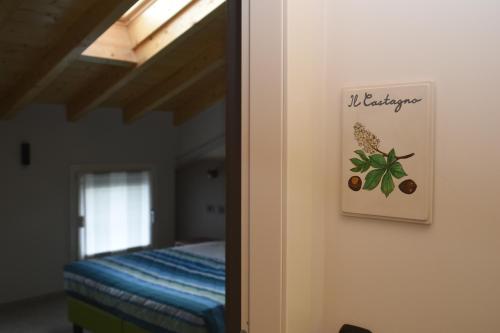 a bedroom with a bed and a sign on the wall at Casale al Foino in Induno Olona