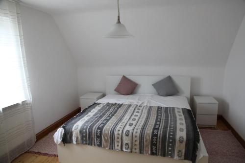 a bedroom with a bed with two pillows on it at Unnerm Keeshawwe in Gossersweiler-Stein