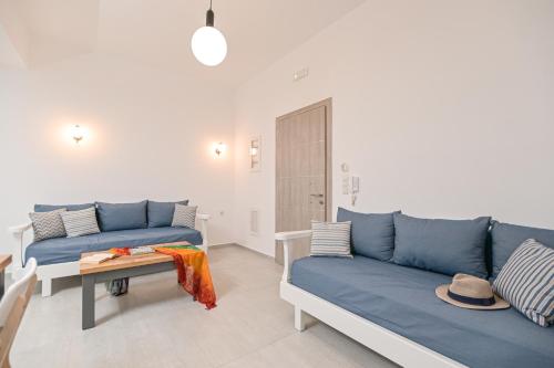 a living room with two blue couches and a table at AZUR in Naxos Chora