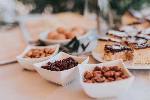a table topped with bowls of desserts and cakes at Colentum Resort Murter in Murter