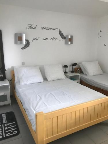 ein Schlafzimmer mit 2 Betten und ein Schild an der Wand in der Unterkunft Villa BAKARA in La Roche-Posay