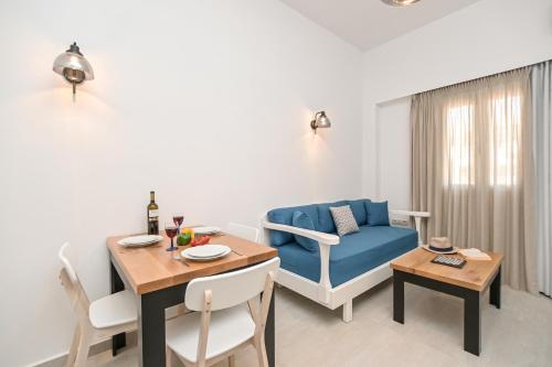 a living room with a table and a blue couch at AZUR in Naxos Chora