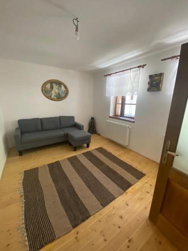 a living room with a couch and a rug at Chalupa Svojanov in Svojanov